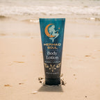 Mermaid Soul body lotion tube on a sandy beach