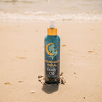 Mermaid Soul body oil bottle on a sandy background