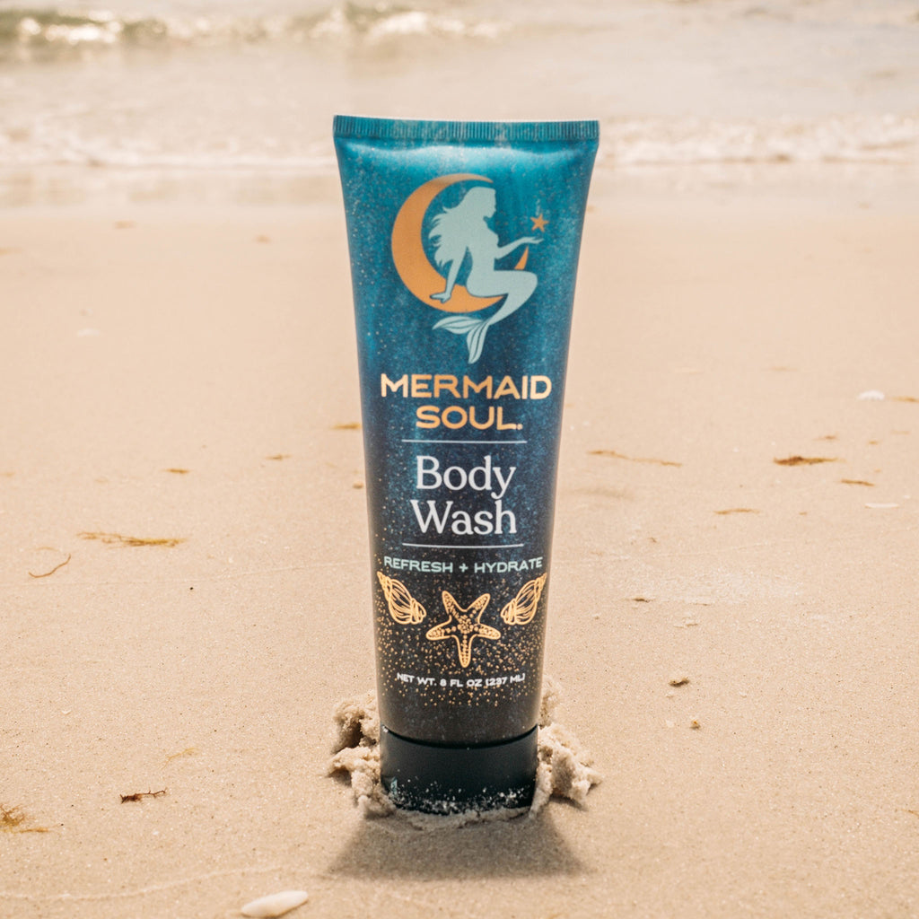 Mermaid Soul body wash tube on a sandy beach