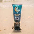 Mermaid Soul body wash tube on a sandy beach